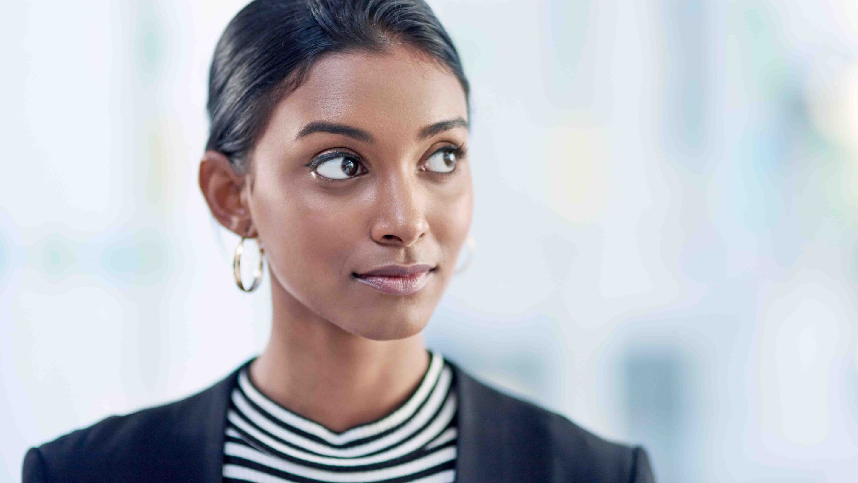 Shot of an attractive young businesswoman looking thoughtful and confident inside her office at work.